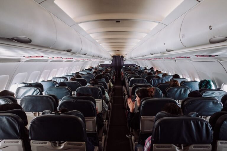 An airplane cabin interior showing rows with window and aisle seats
