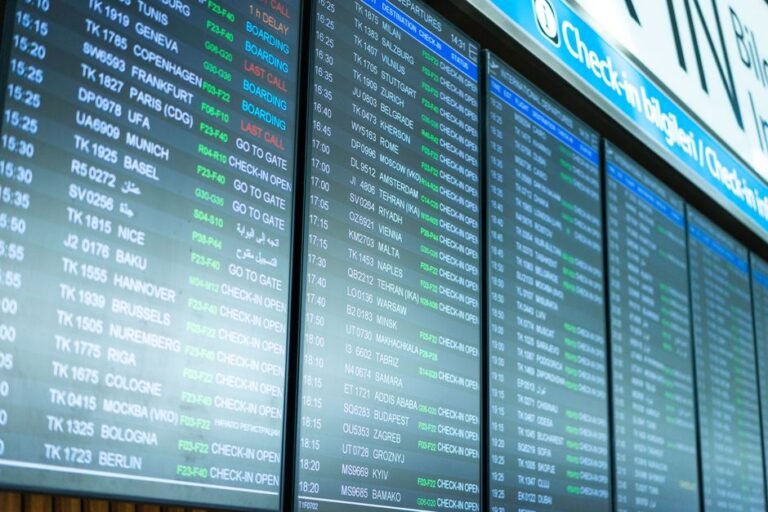 An airport departure board showing a list of connecting flights