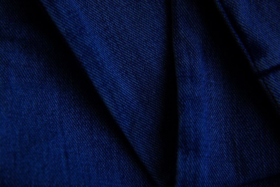 Close-up macro shot of denim fabric showing its diagonal twill weave texture