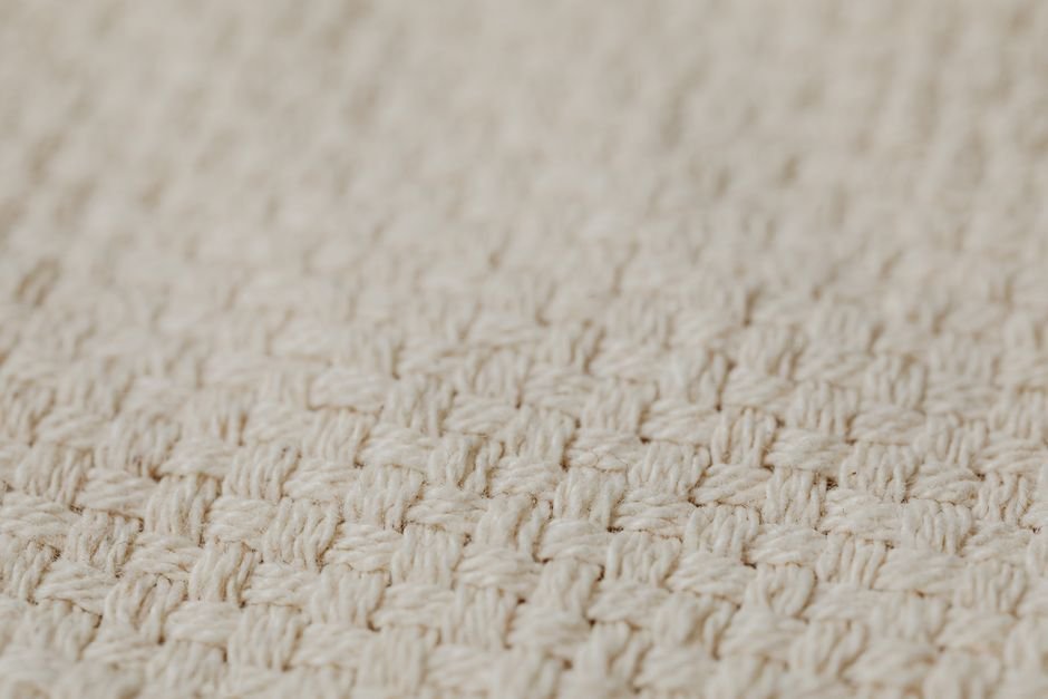 A close-up view of tightly woven cotton fabric showing individual threads