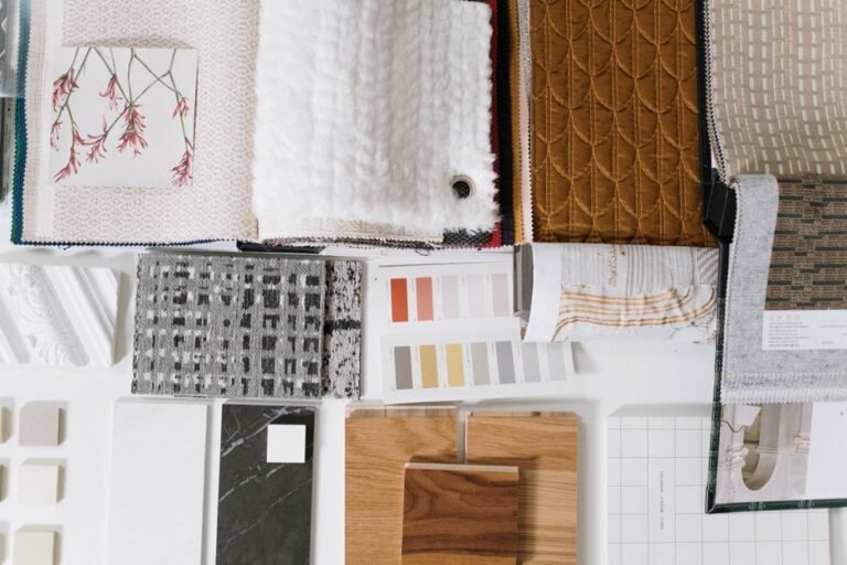 Fabric swatches arranged into four seasonal color groups on a table