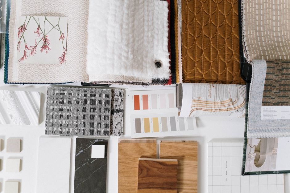 Fabric swatches arranged into four seasonal color groups on a table