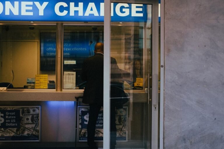 A currency exchange counter with rate boards at an airport terminal