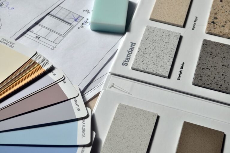 Paint swatches in different sheens fanned out on a wooden table