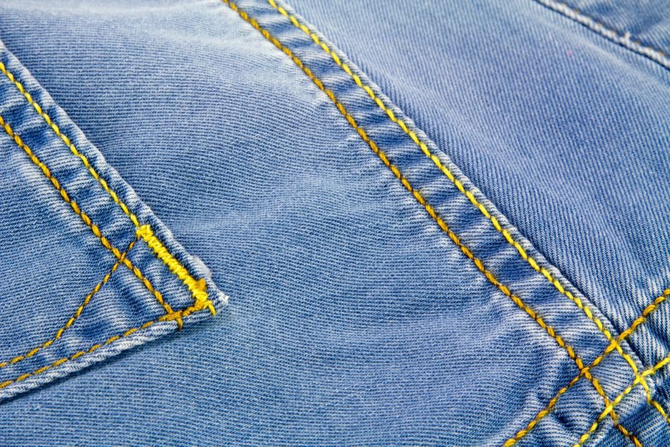A pair of jeans with visible natural fade lines at the knees and hips