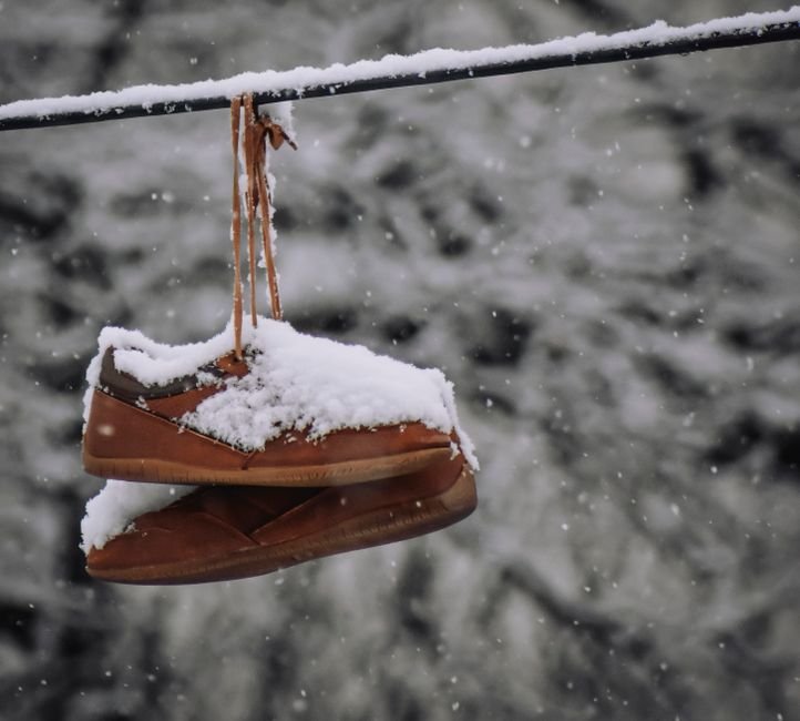 A pair of insulated winter boots standing in fresh snow