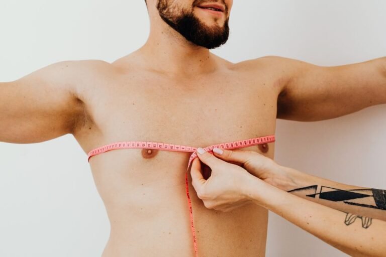 A person using a tape measure to measure their chest for online clothing sizing