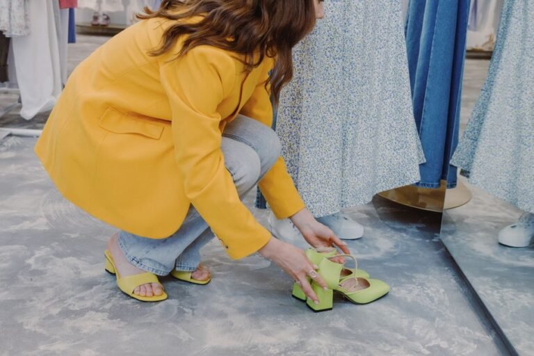 A person trying on shoes and checking the fit while standing in a shoe store