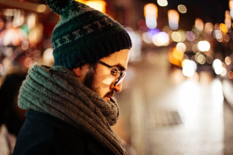 A person outdoors in cold weather with a wool scarf wrapped snugly around their neck