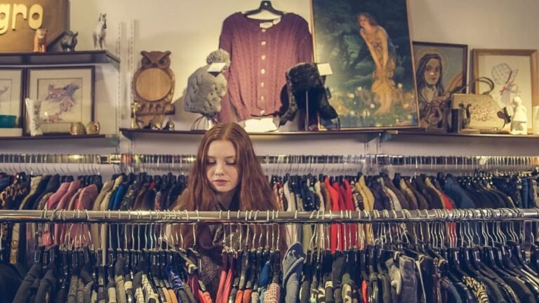 A rack of vintage clothing hanging in a secondhand shop
