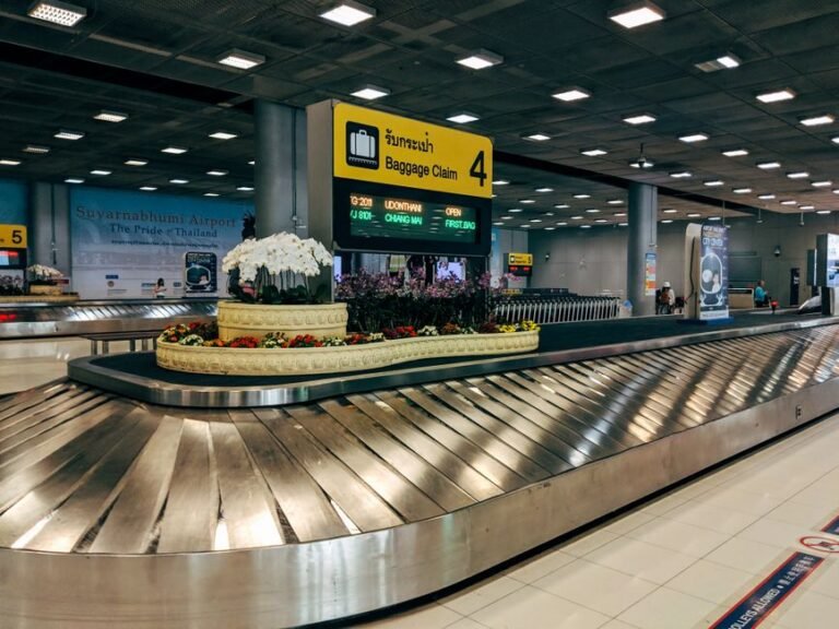 A hard-shell suitcase moving along an airport baggage carousel