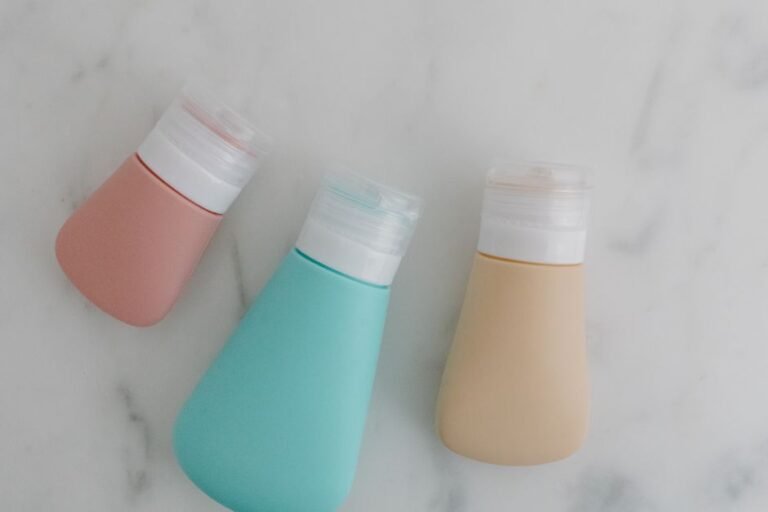 A clear zippered toiletry bag holding small travel-size bottles and tubes