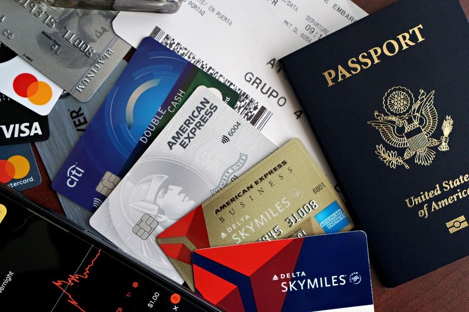 A credit card resting on top of a paper boarding pass