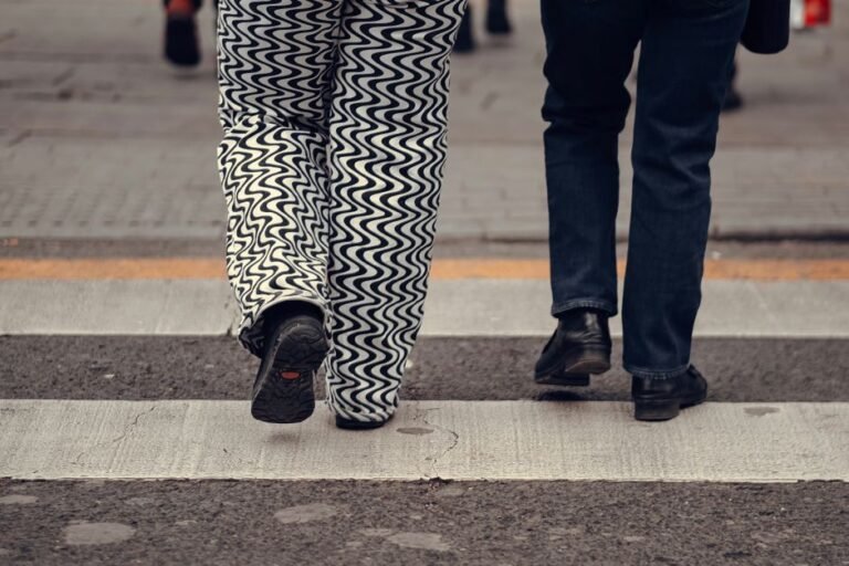 Two pairs of pants laid flat side by side, one slim fit and one regular fit